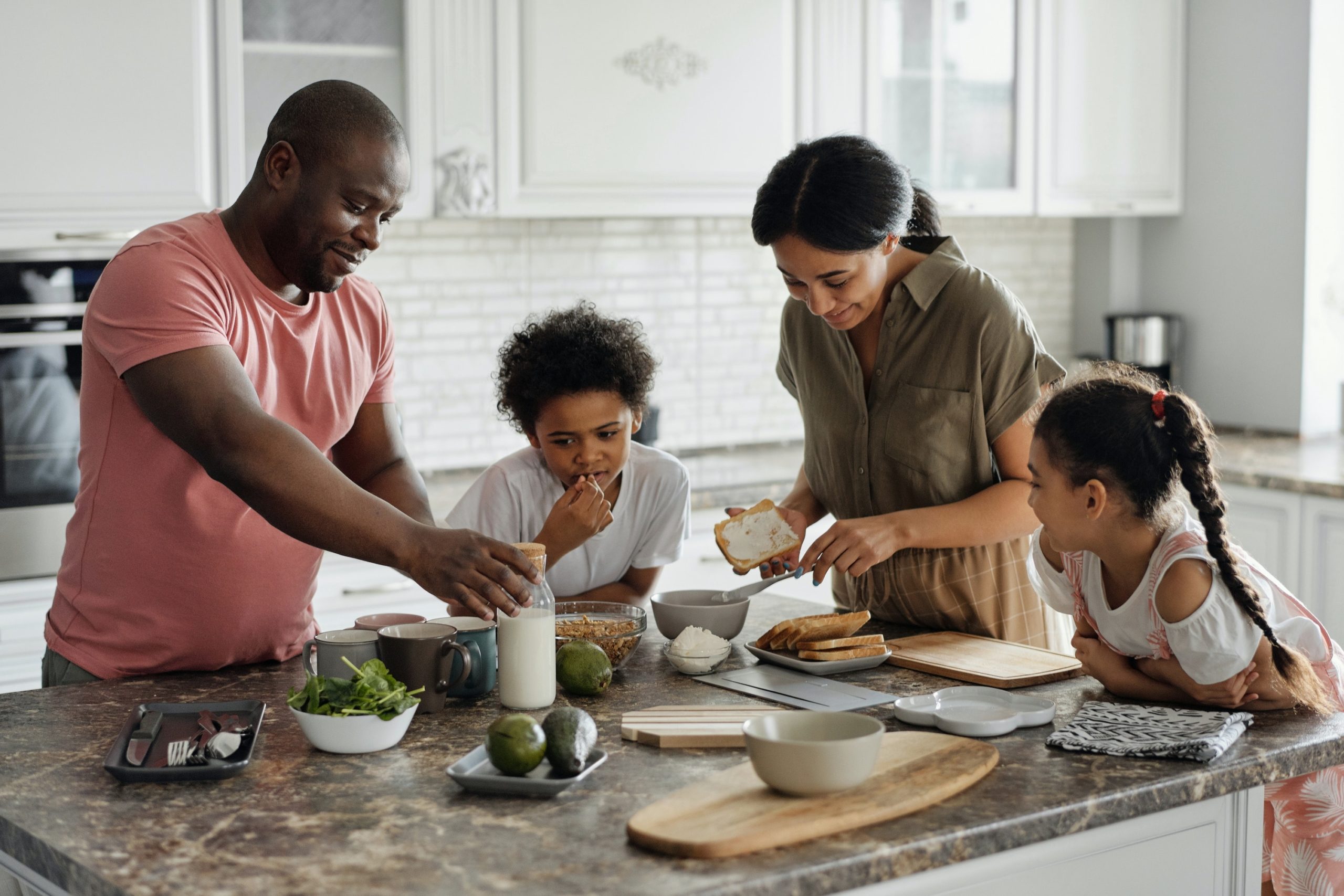 Family Making Breakfast with Milk