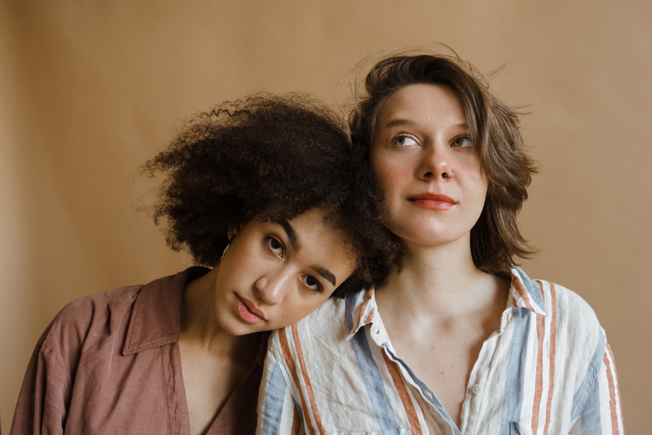 Two women wearing minimalist make-up