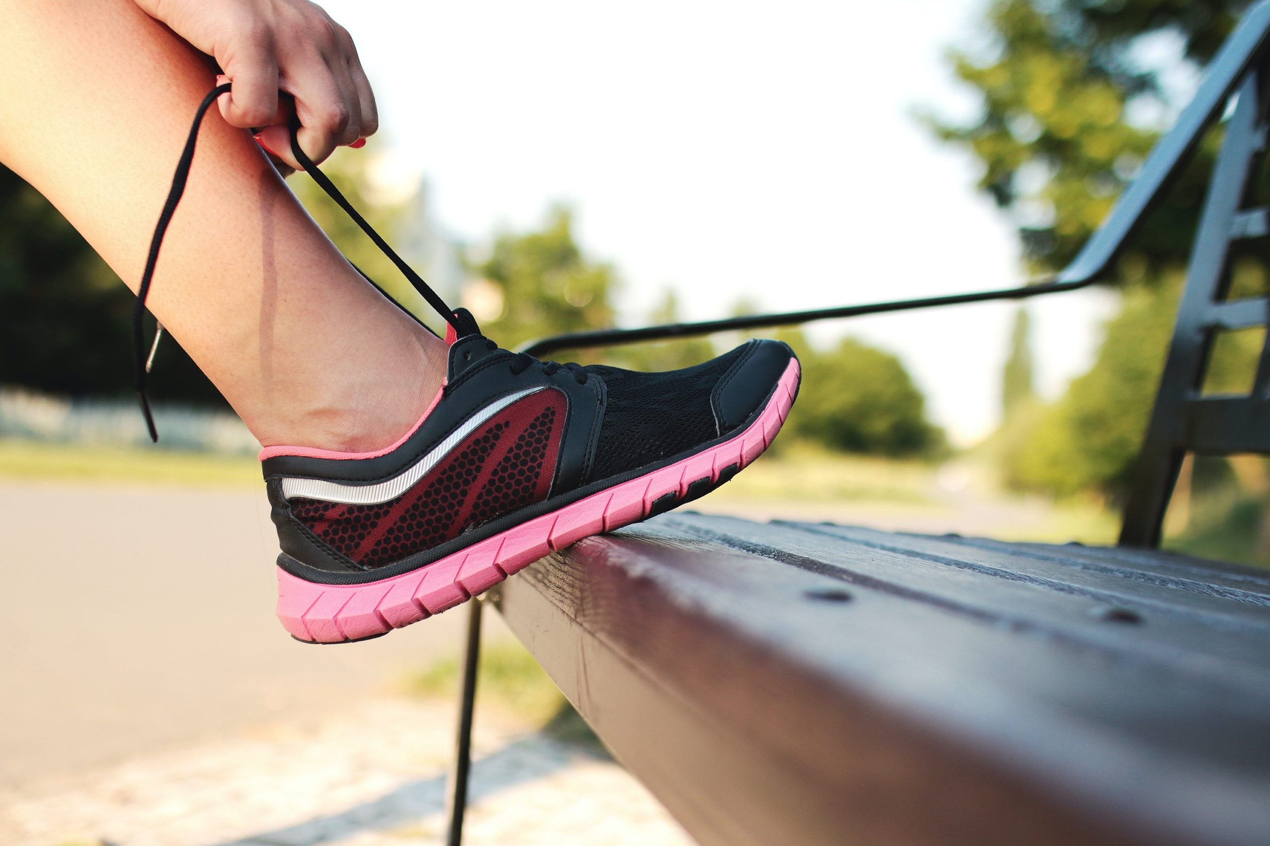 Woman tying her shoe to exercise