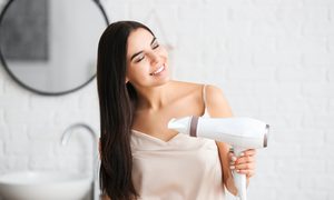 Woman blowdrying her hair