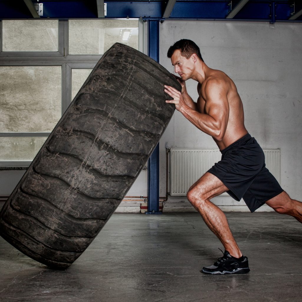 man flipping tire during workout