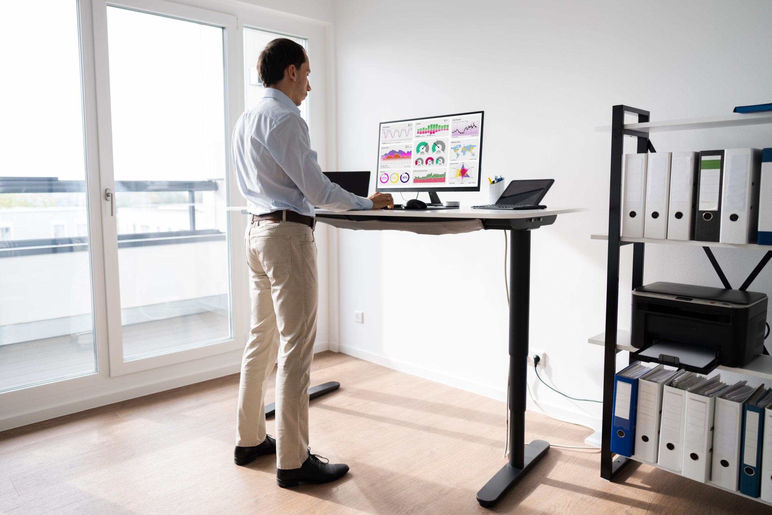 man standing at desk in office space
