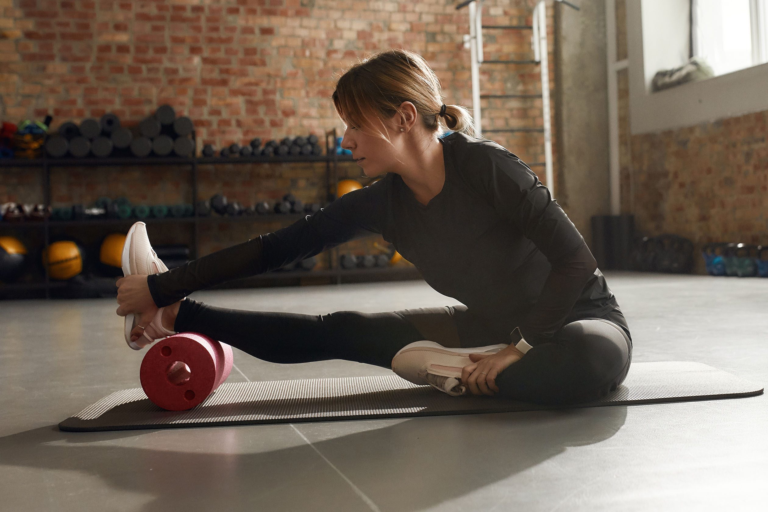 woman stretching with foam roller