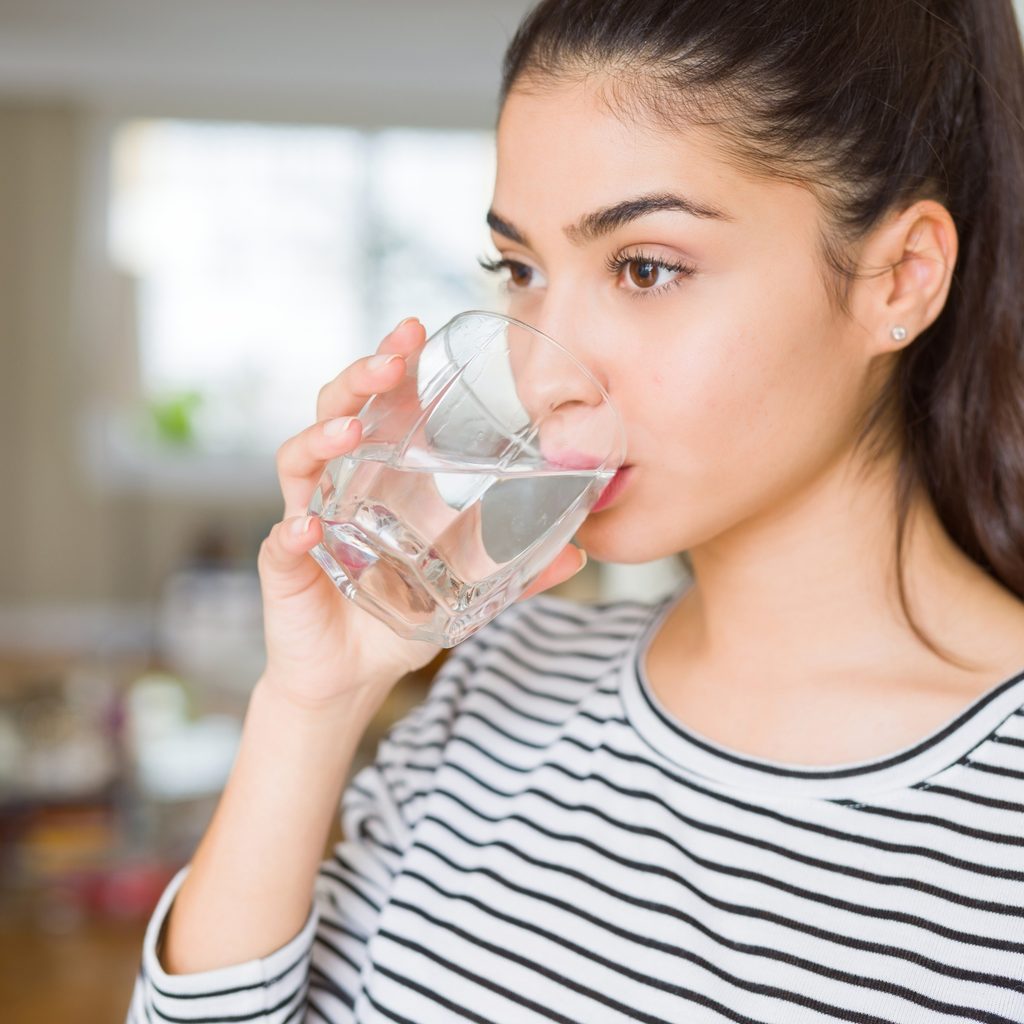 woman drinking a glass of water