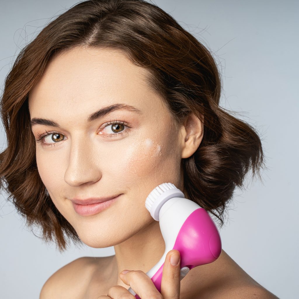 woman exfoliation with rotating brush