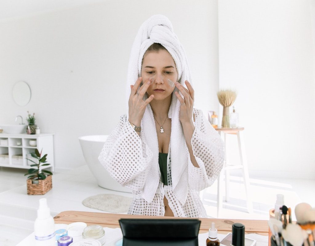 A woman doing her skin care routine