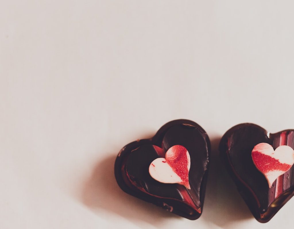 2 chocolate heart desserts on a table