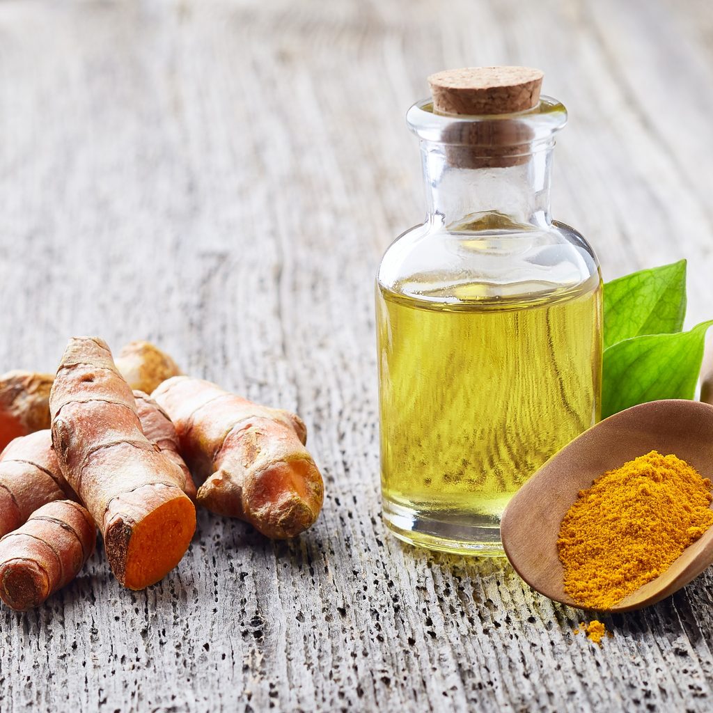 turmeric root essential oil on table