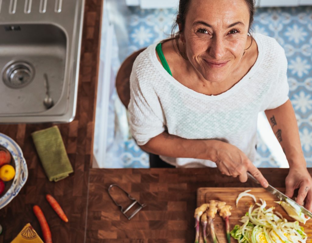 A woman cooks vegan food