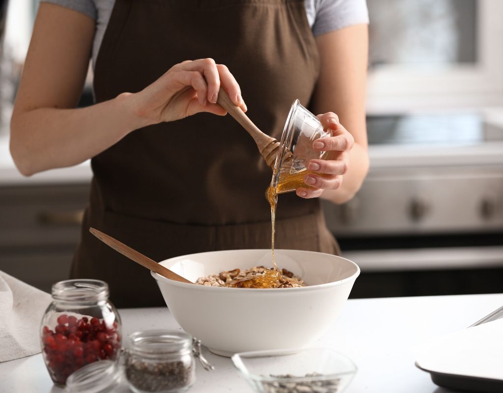A woman makes granola