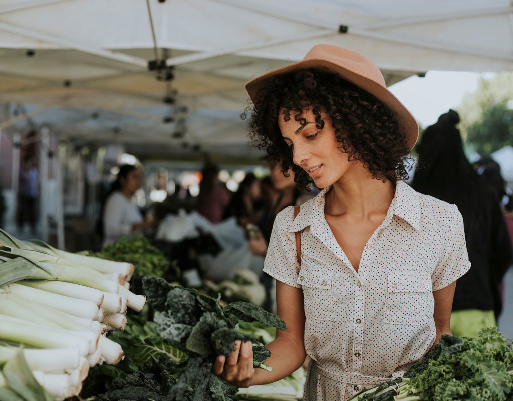 A woman shops for leafy greens
