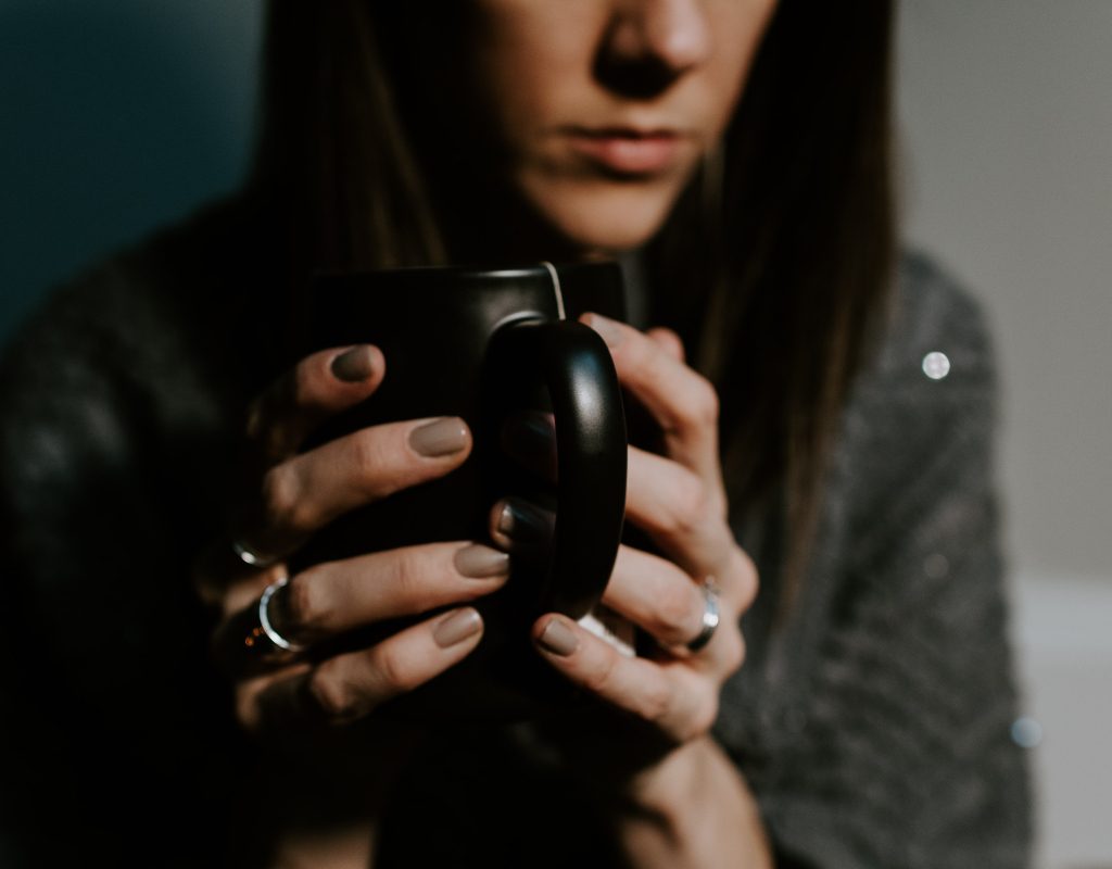 A woman holds a tea cup