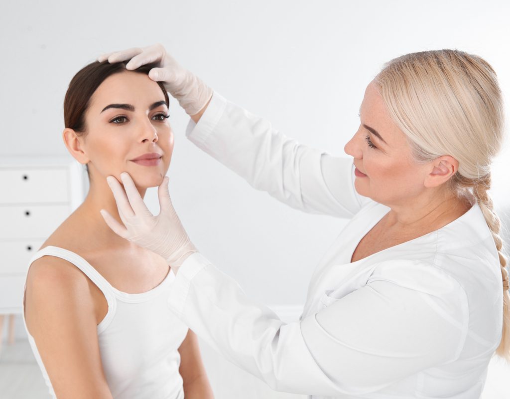 Dermatologist examines patient