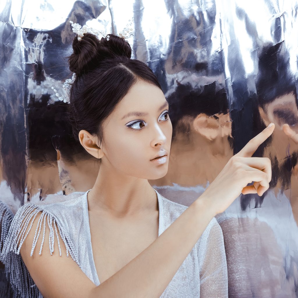 Girl looks at distorted reflections