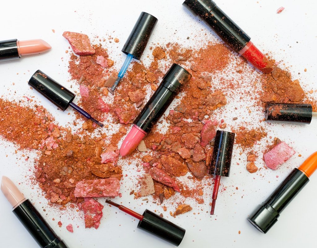 Makeup artistically laid out all over a table.