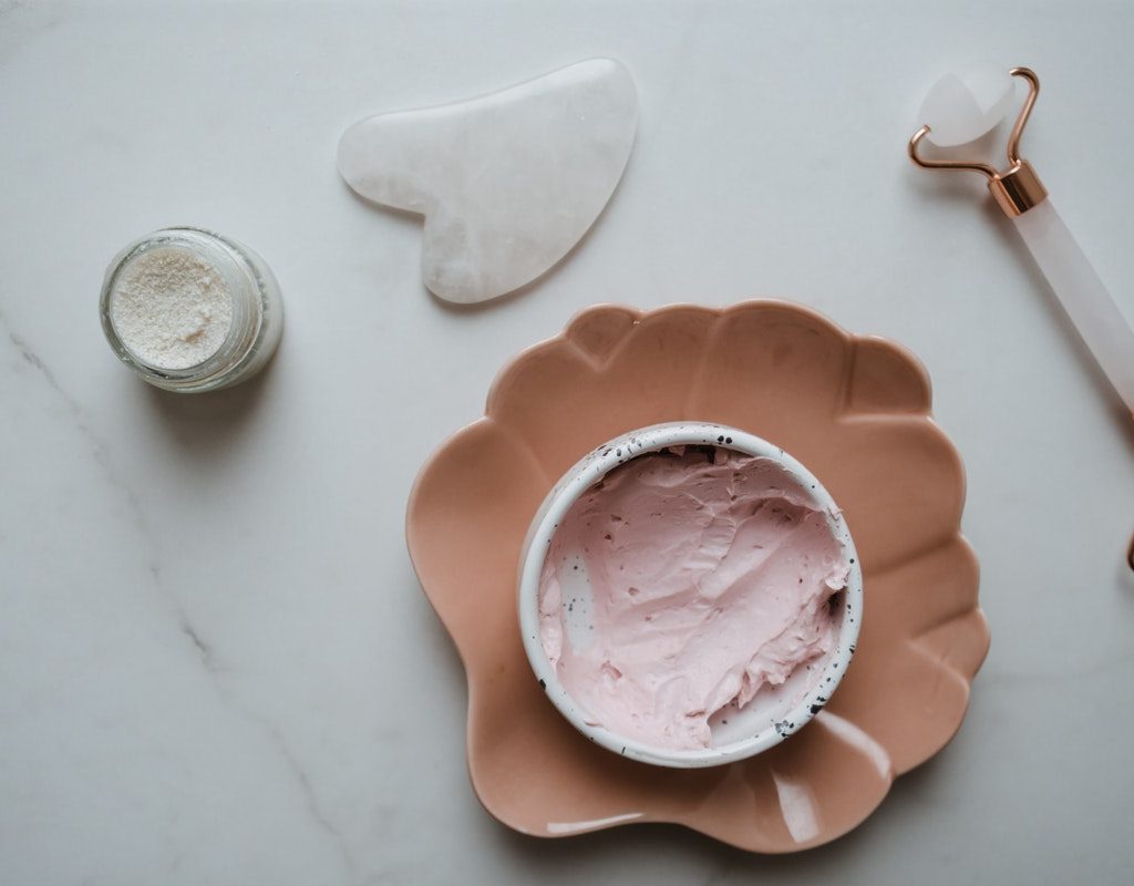 Face roller and other skin care items on a table.