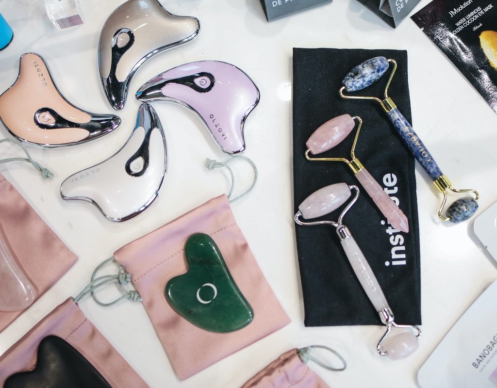 Face rollers and under eye masks laid out on a table.