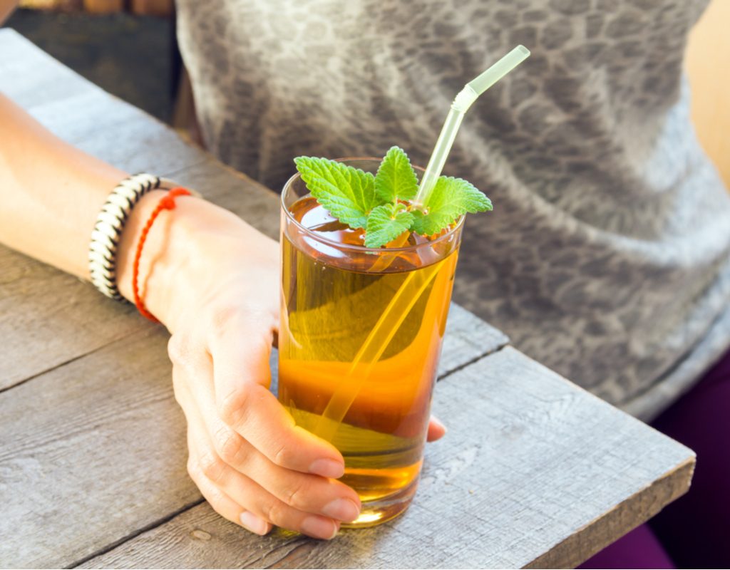 A woman drinking kombucha