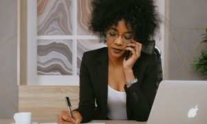 Woman on the phone while writing