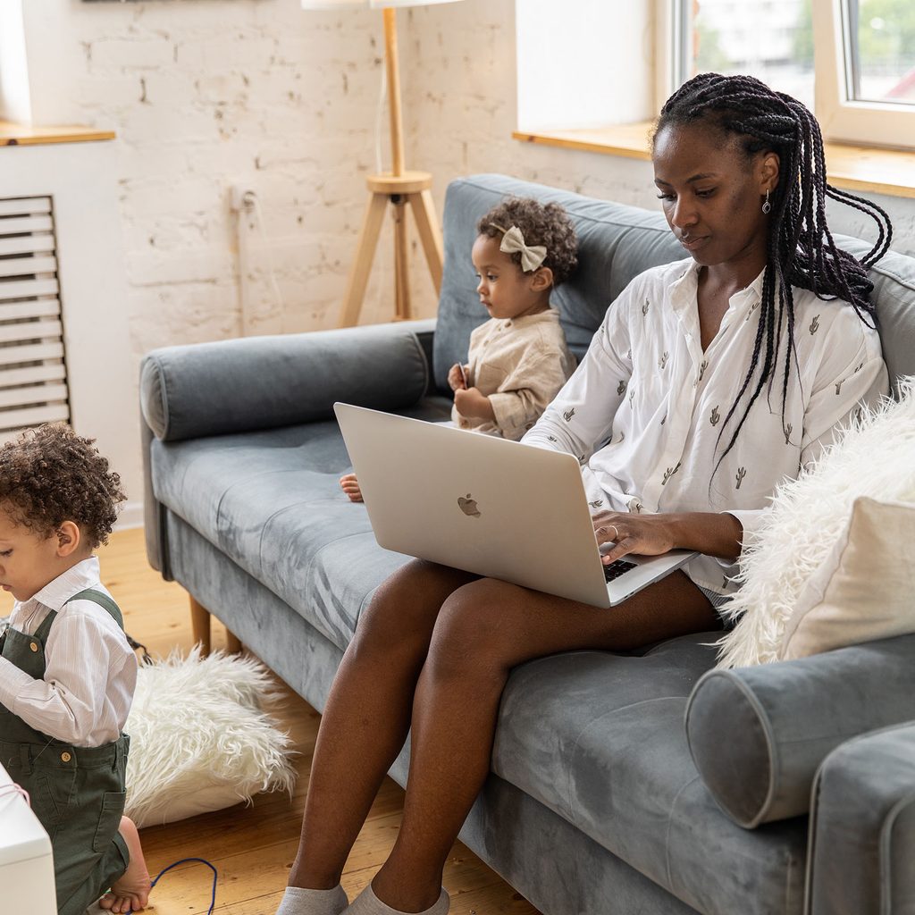 Woman working remotely with her children