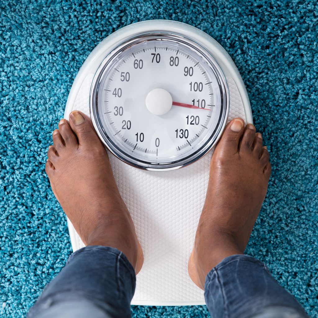 woman's feet on bathroom scale