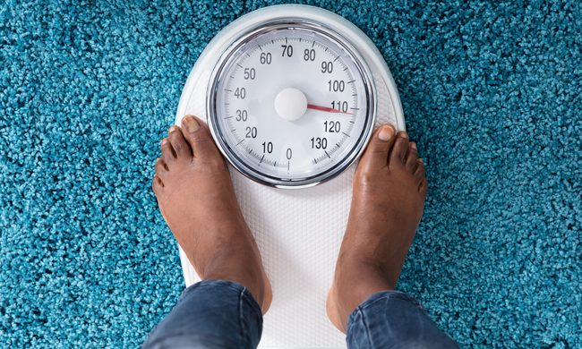 woman's feet on bathroom scale