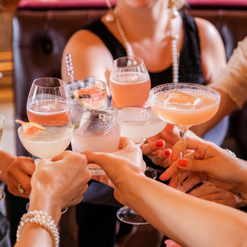 A group of friends toasting with cocktails