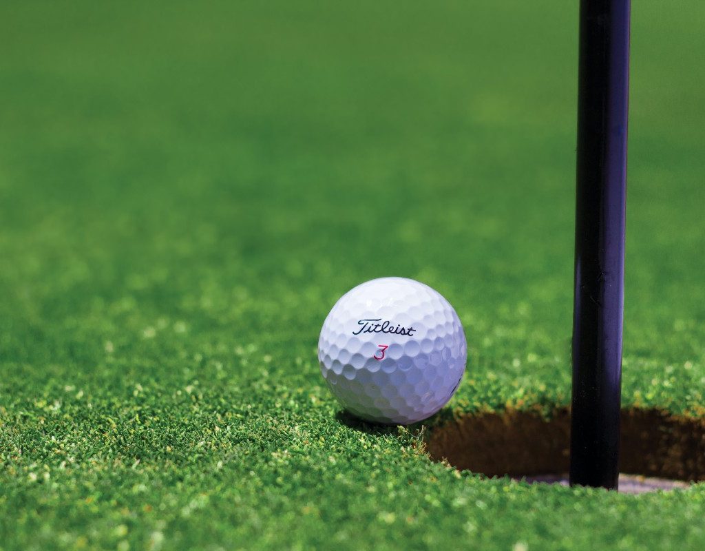 golf-ball-near-hole-on-green