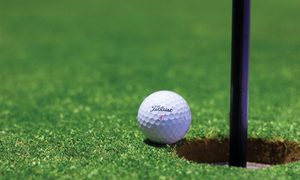 golf-ball-near-hole-on-green