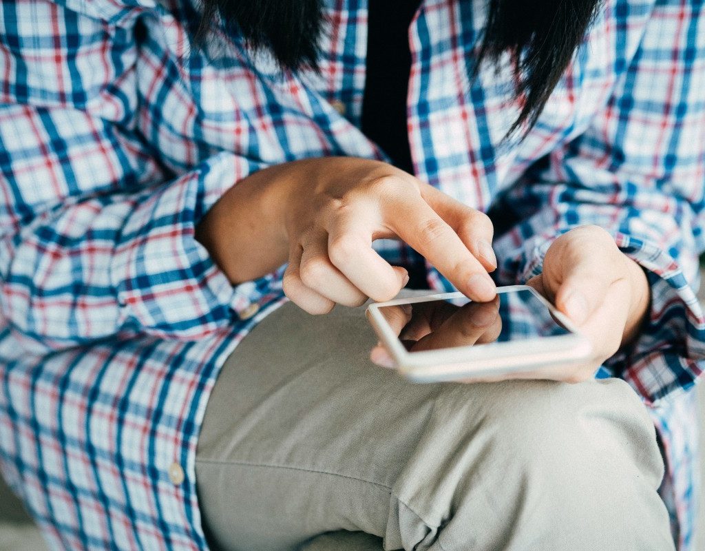 person-looking-at-phone-on-step