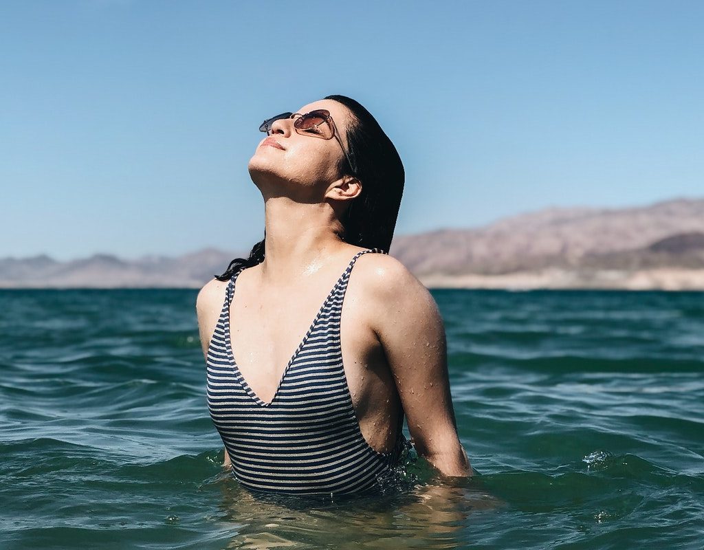 A woman enjoying the sun while being in the water.