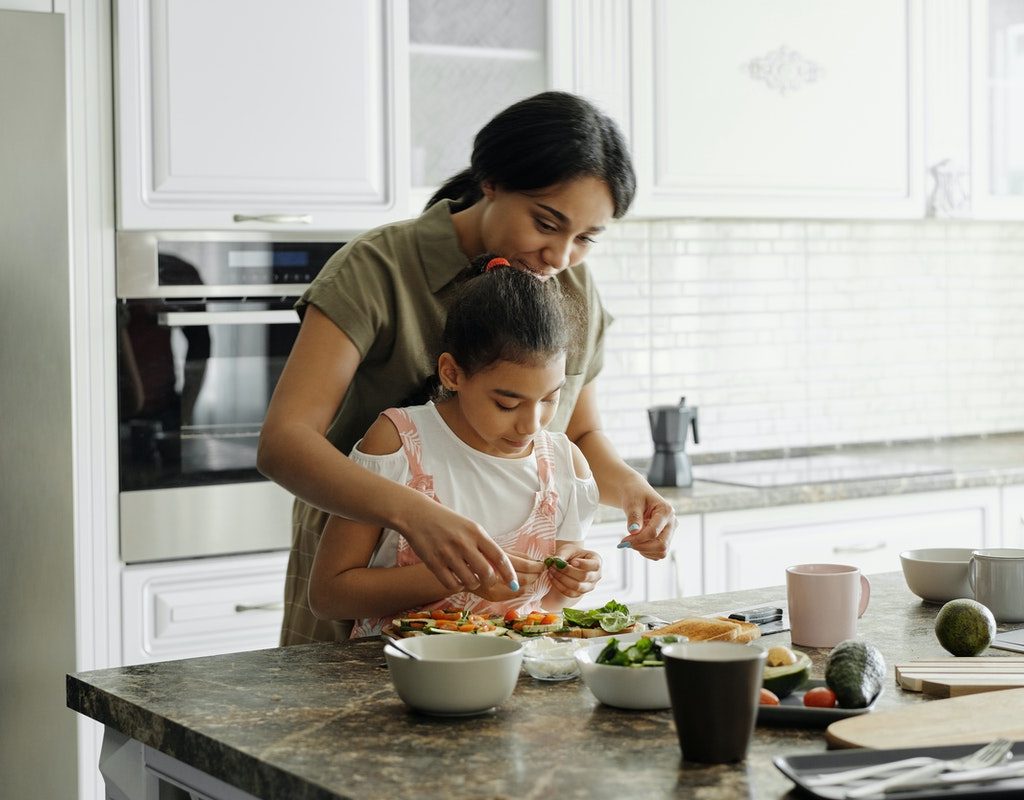 Mother and daughter cooking in the kitchen.