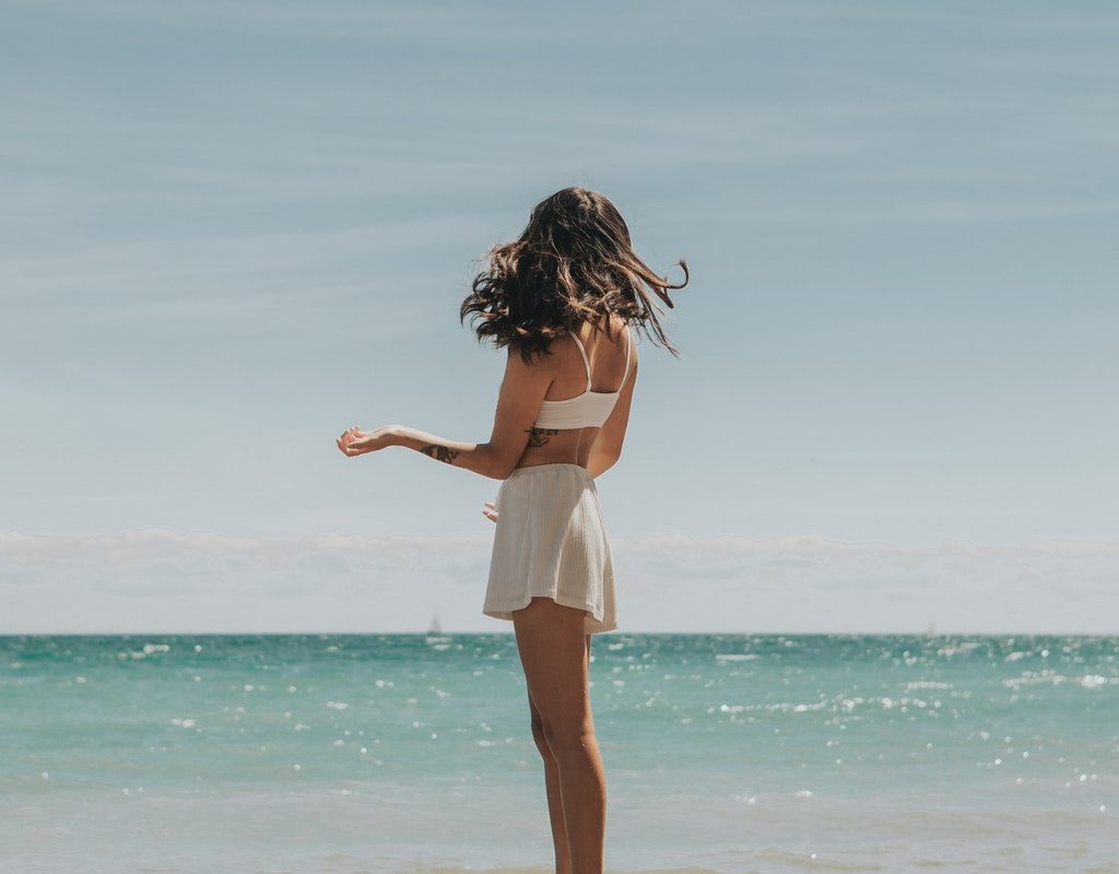 A woman standing on the beach.