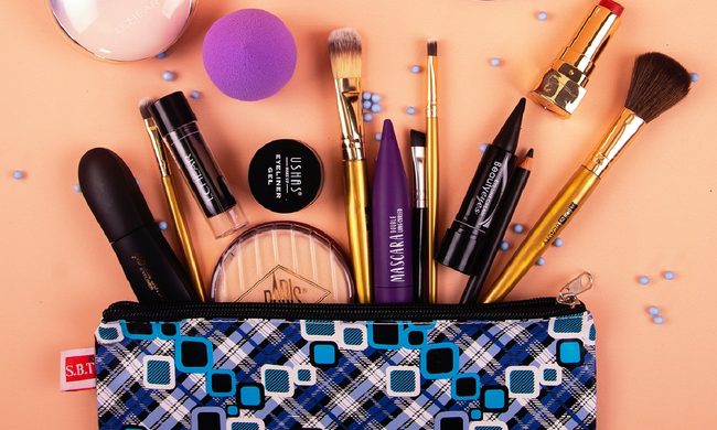 Makeup items exploding out of a makeup bag.