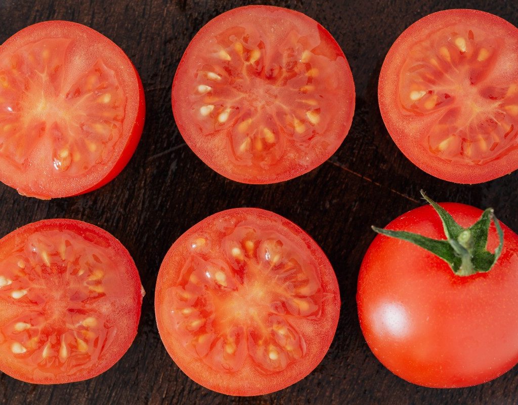 tomato-halves-on-dark-wood-table