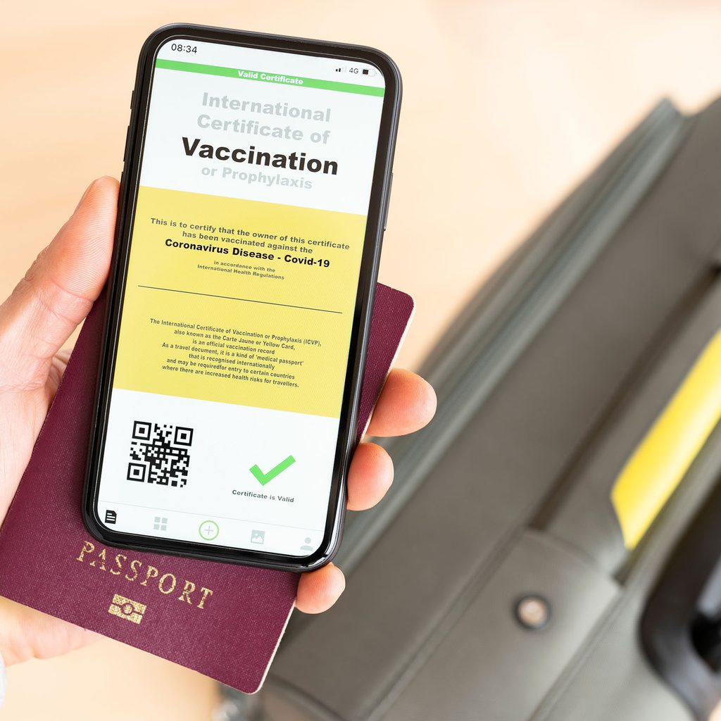 Traveler with a suitcase and vaccine passport