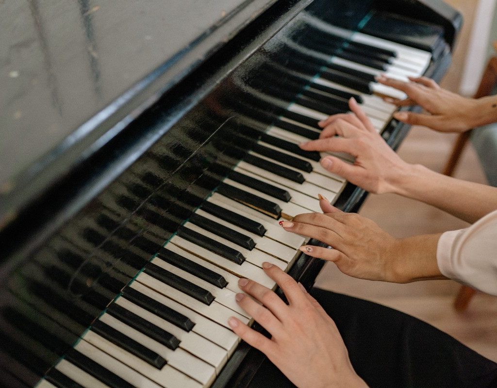 two-women-playing-piano