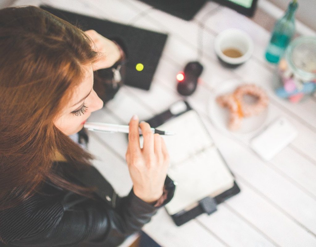 woman-at-desk-with-pen-thinking