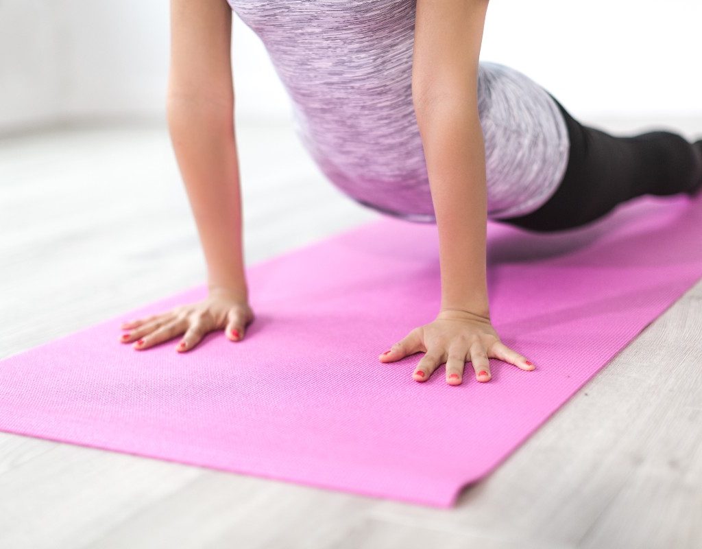 woman-doing-yoga-pink-mat
