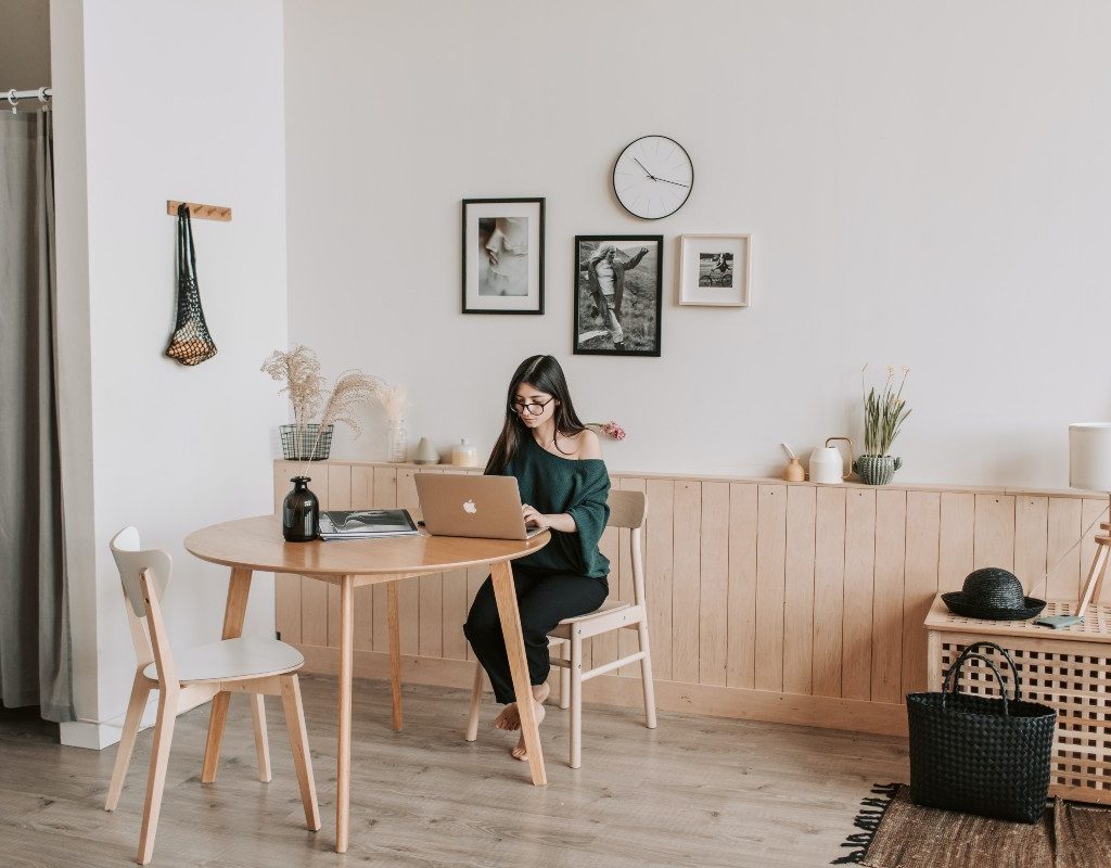 woman-sitting-at-small-table-on-computer