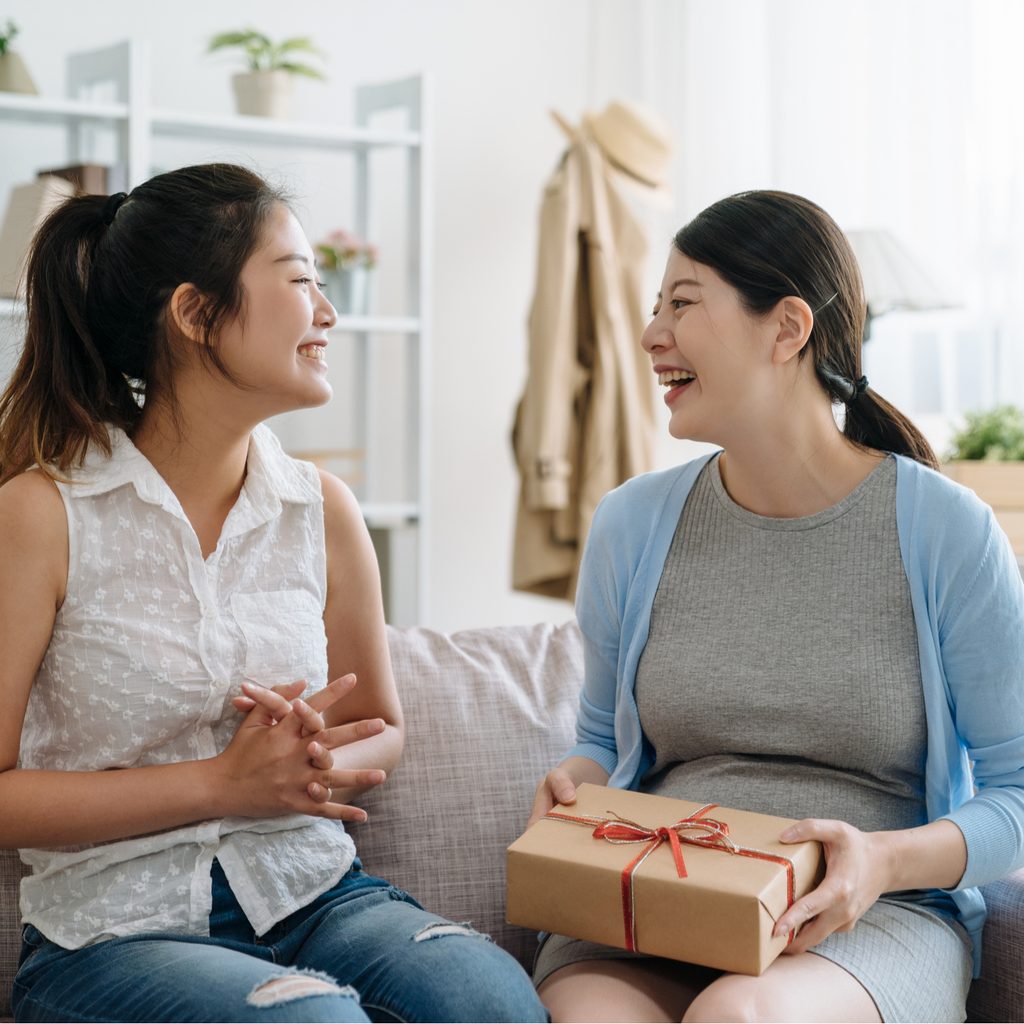 Woman giving a gift to another woman