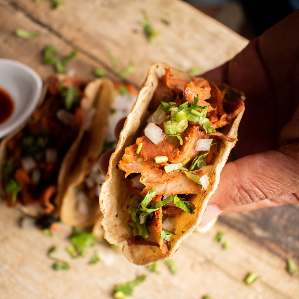 Person holding a taco