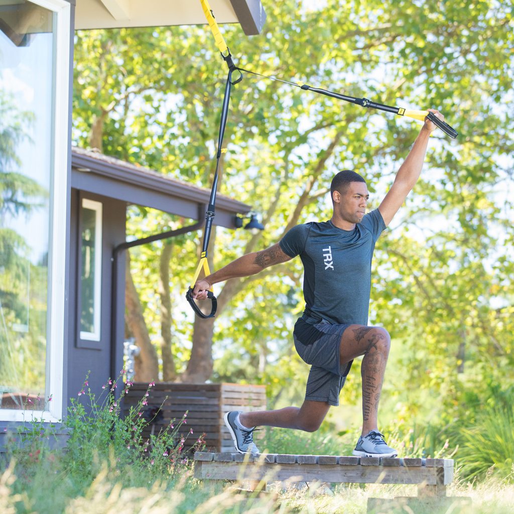 Man working out on porch with TRX