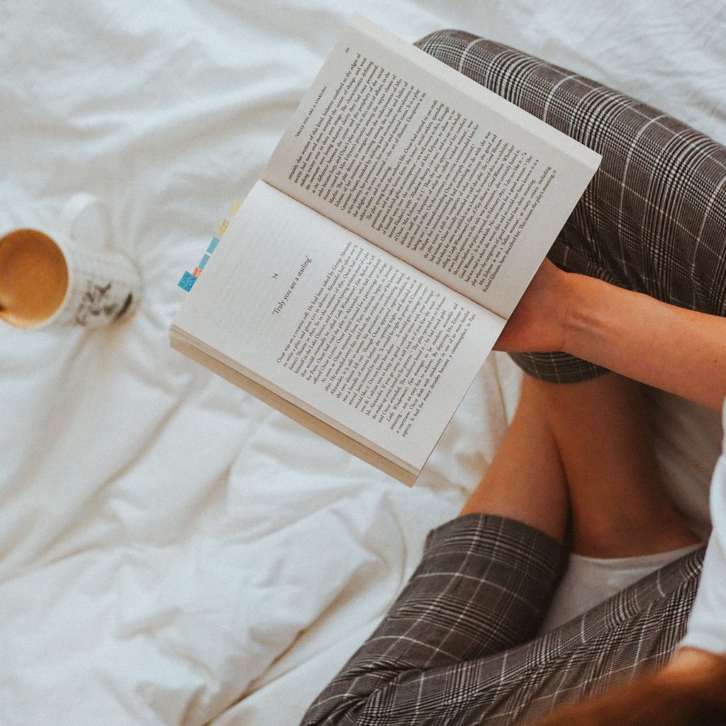 Woman reading a book in bed