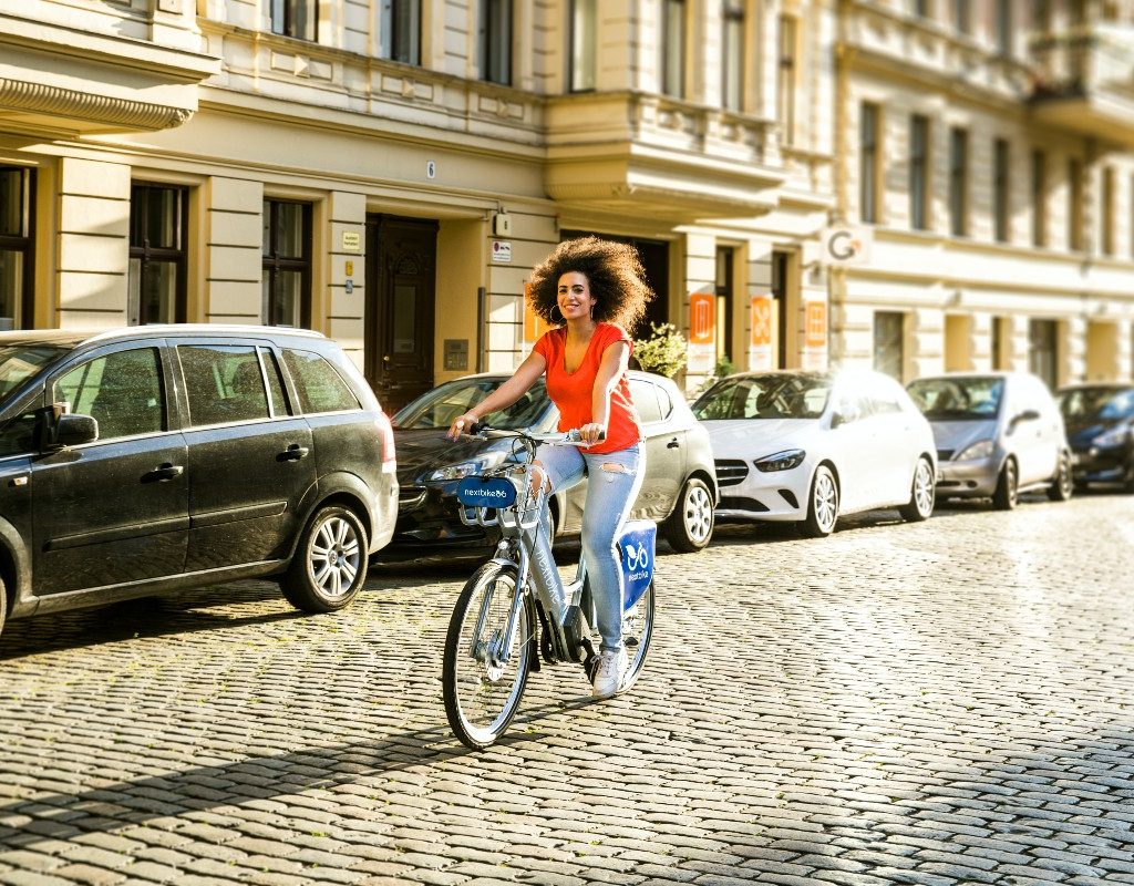 woman riding bike on brick road