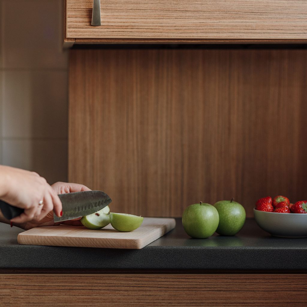 Woman slicing fruit in the kitchen