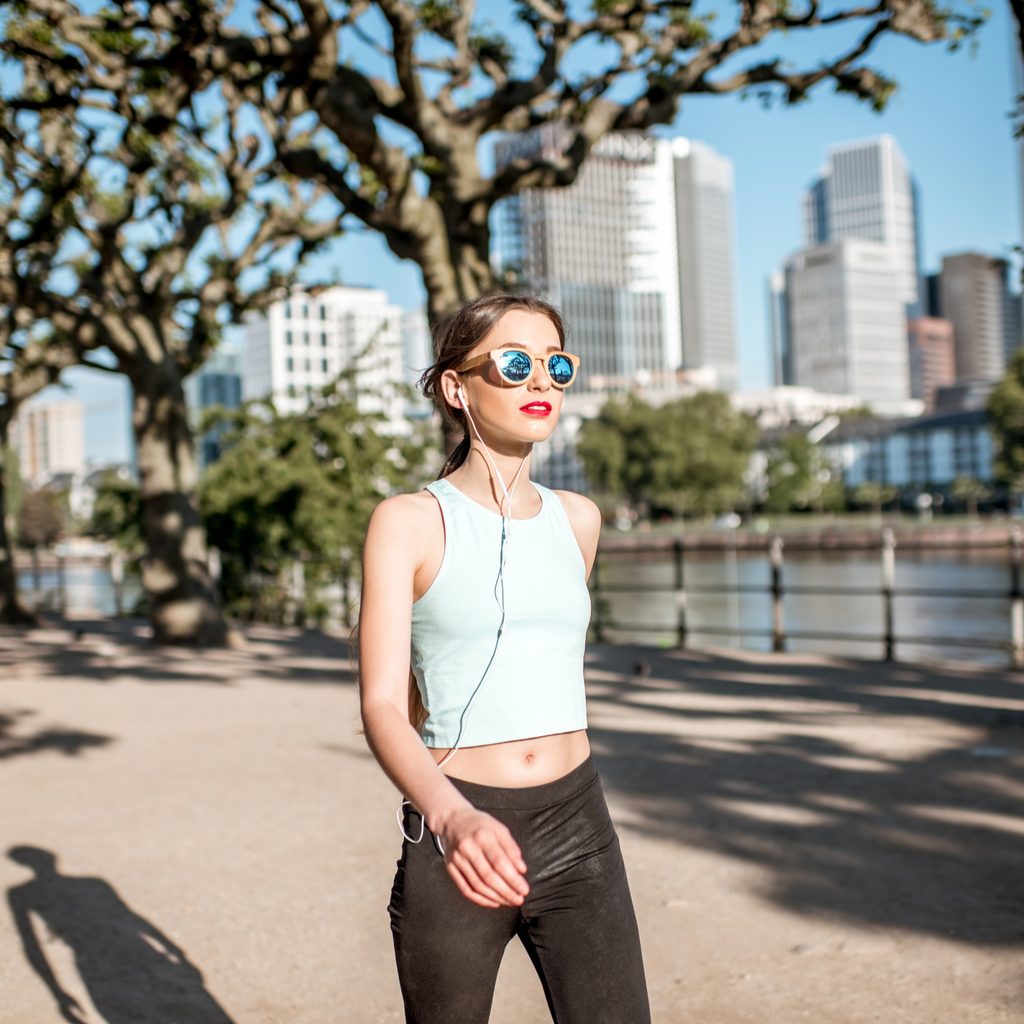 Woman walking with skyline in background