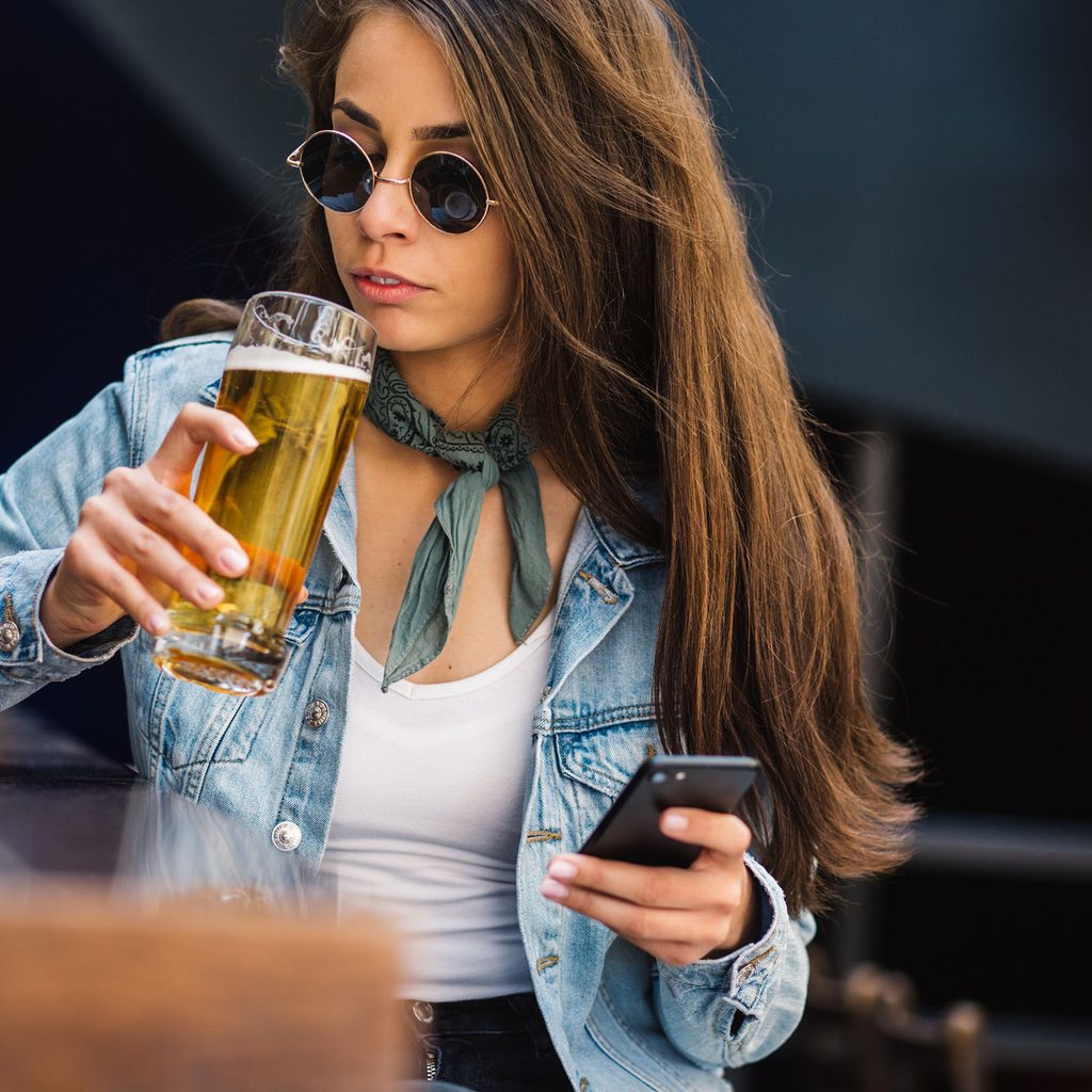 Woman wearing a tank top and jean jacket