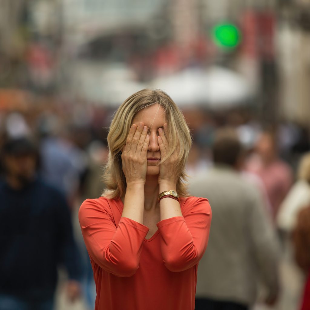 woman having anxiety attack in public place