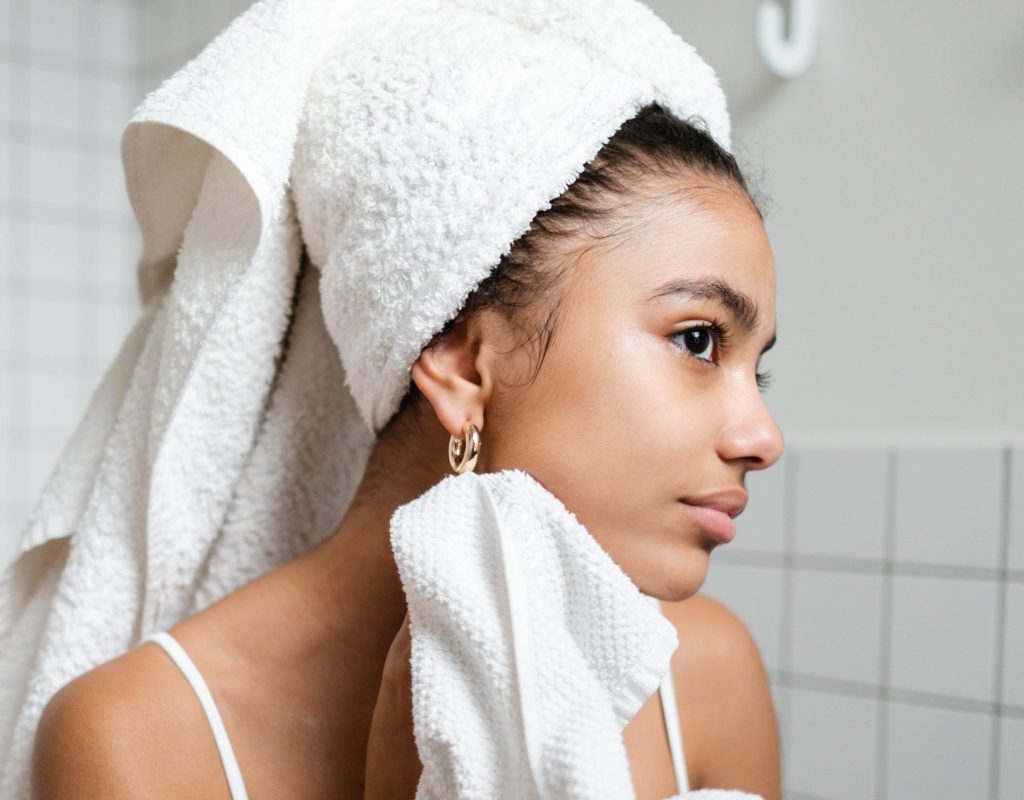 young woman wearing bath towel with smooth skin